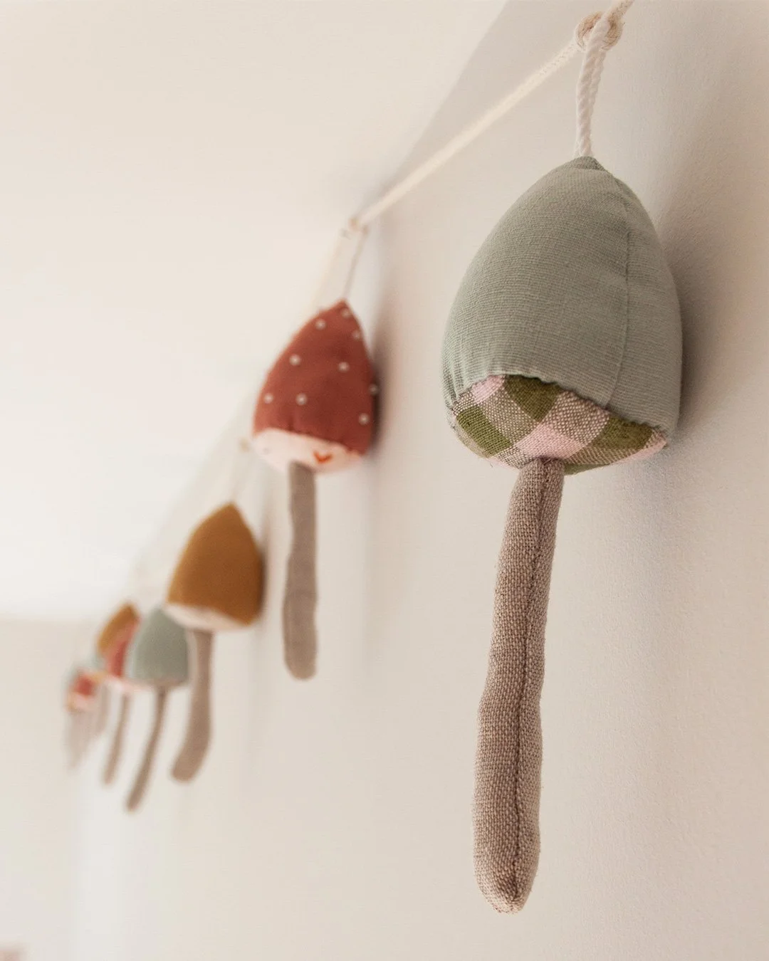 A whimsical garland is a great nursery decor idea on a budget