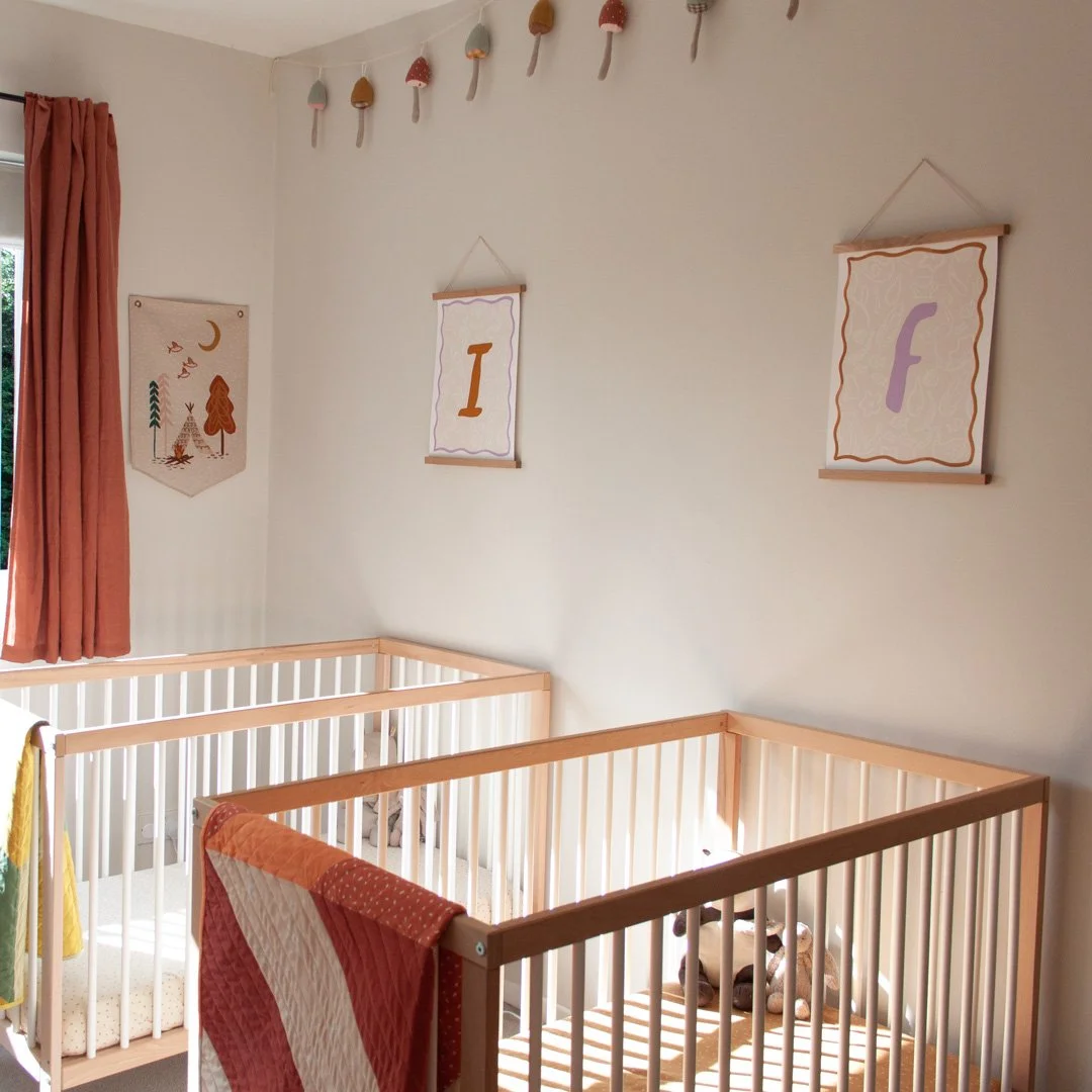 Initial prints in a twin girls nursery