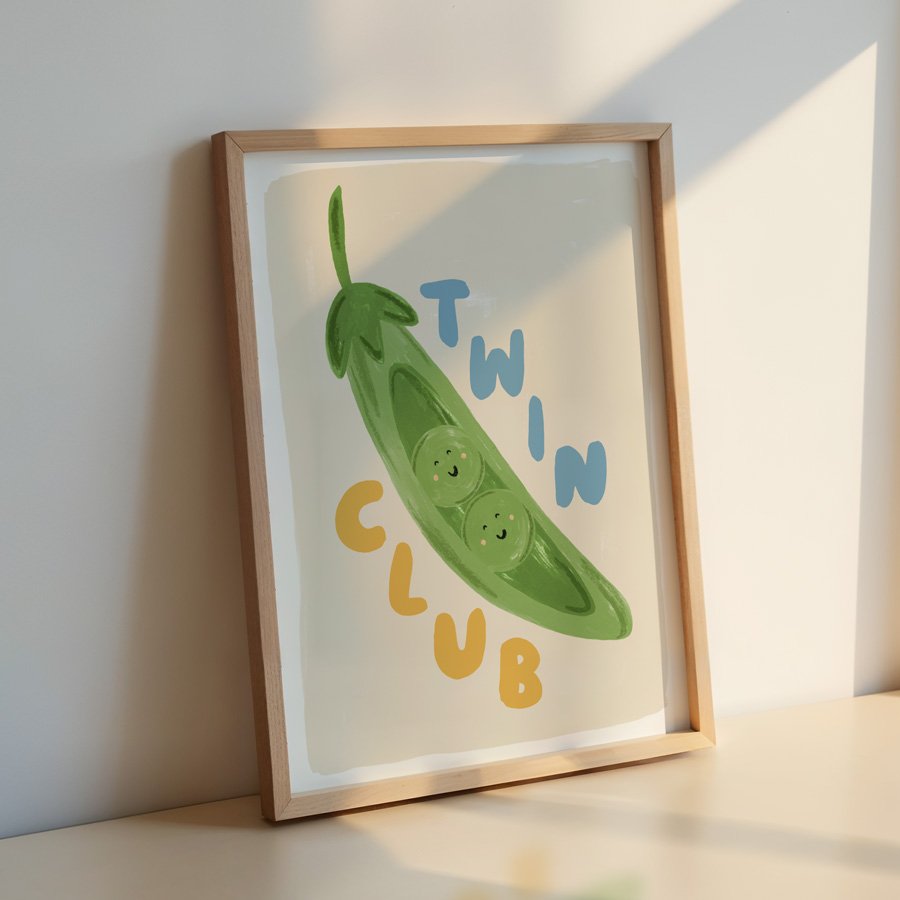 Peas in a Pod Twin Nursery Print Blue / Yellow in wooden frame leaning against wall