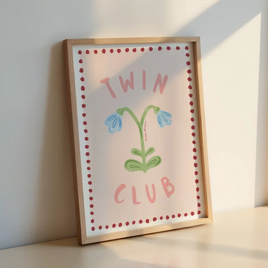 Twin Flower print in pink and burgundy in wooden frame against wall