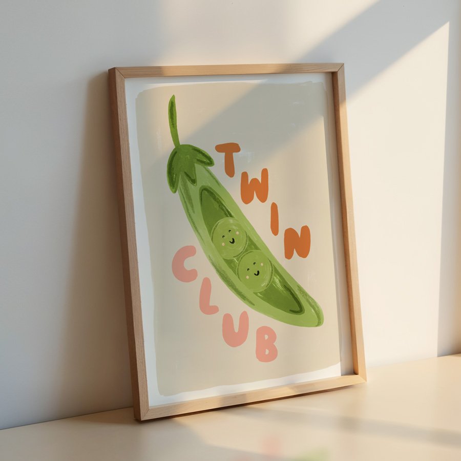Peas in a Pod Twin Nursery Print orange / pink in wooden frame leaning against wall