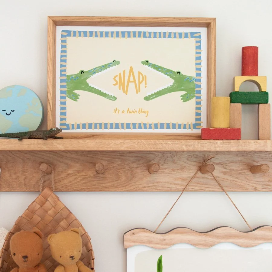 Crocodiles Twin Nursery Print in vintage blue and butter yellow styled on wooden peg shelf