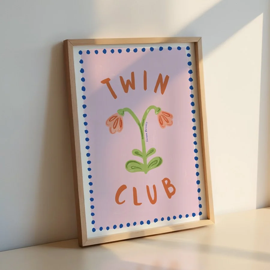 Twin Flower print in lilac and cobalt in wooden frame leaning against wall