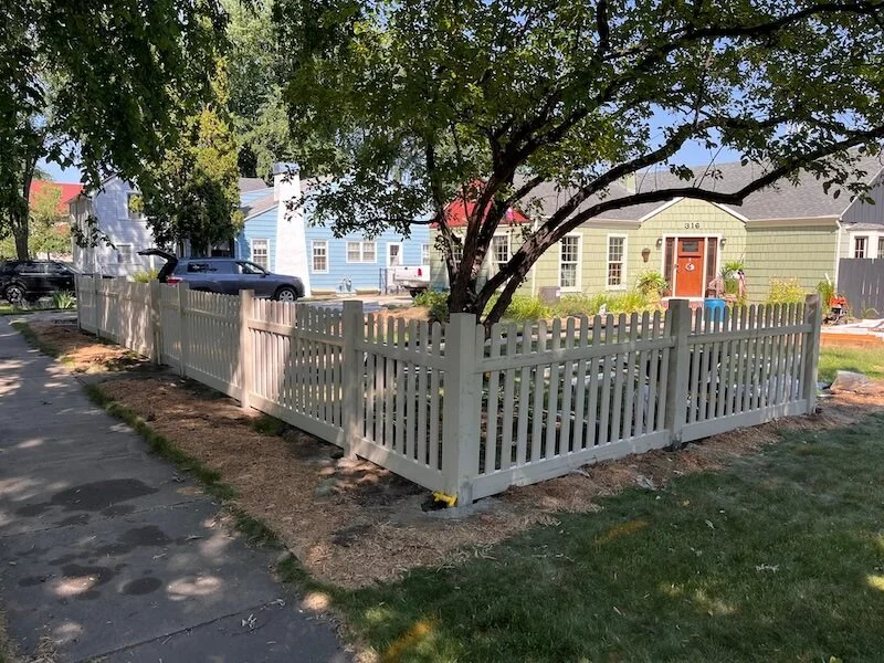 Vinyl picket fence installation in progress