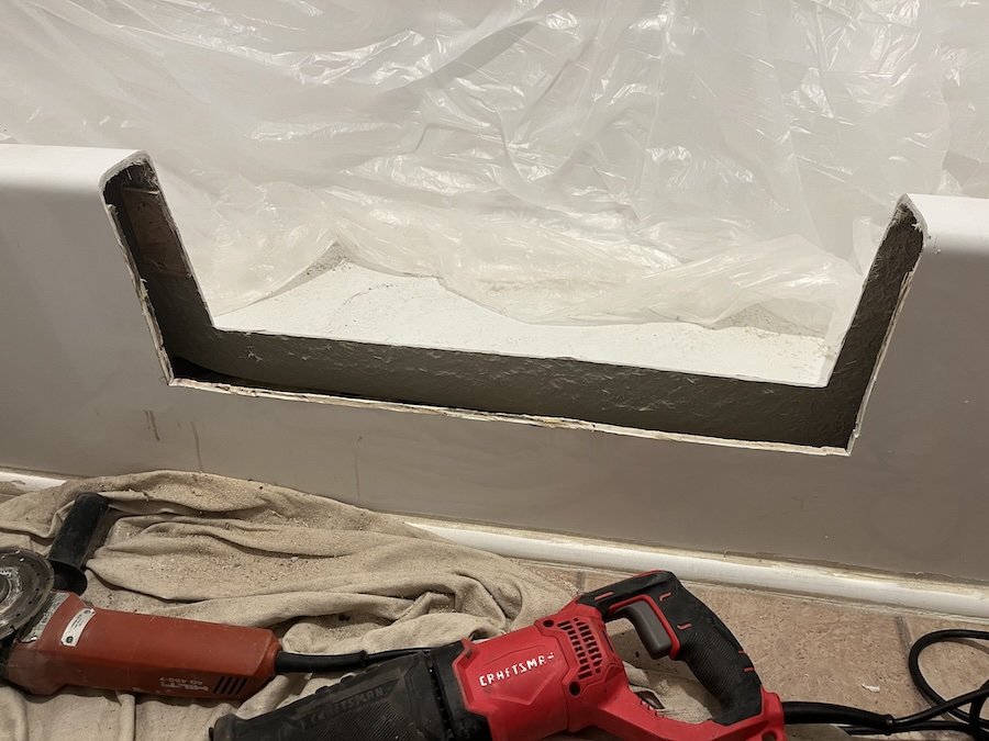 Cut fiberglass tub for installing shower walk-in conversion kit