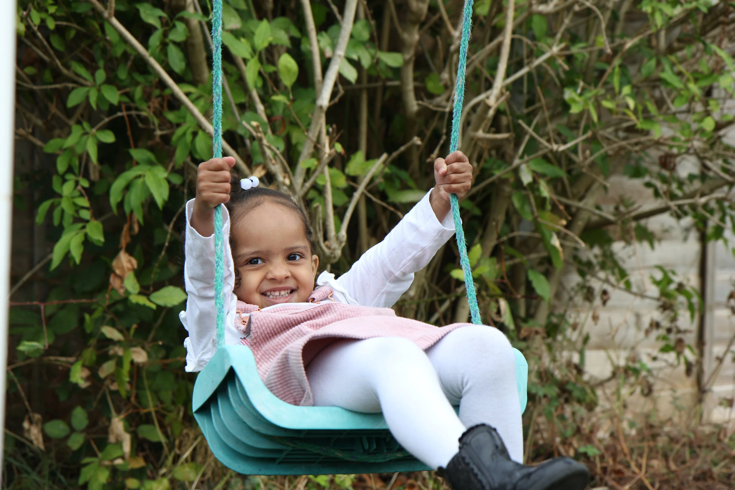 Child playing on swing in the Garden