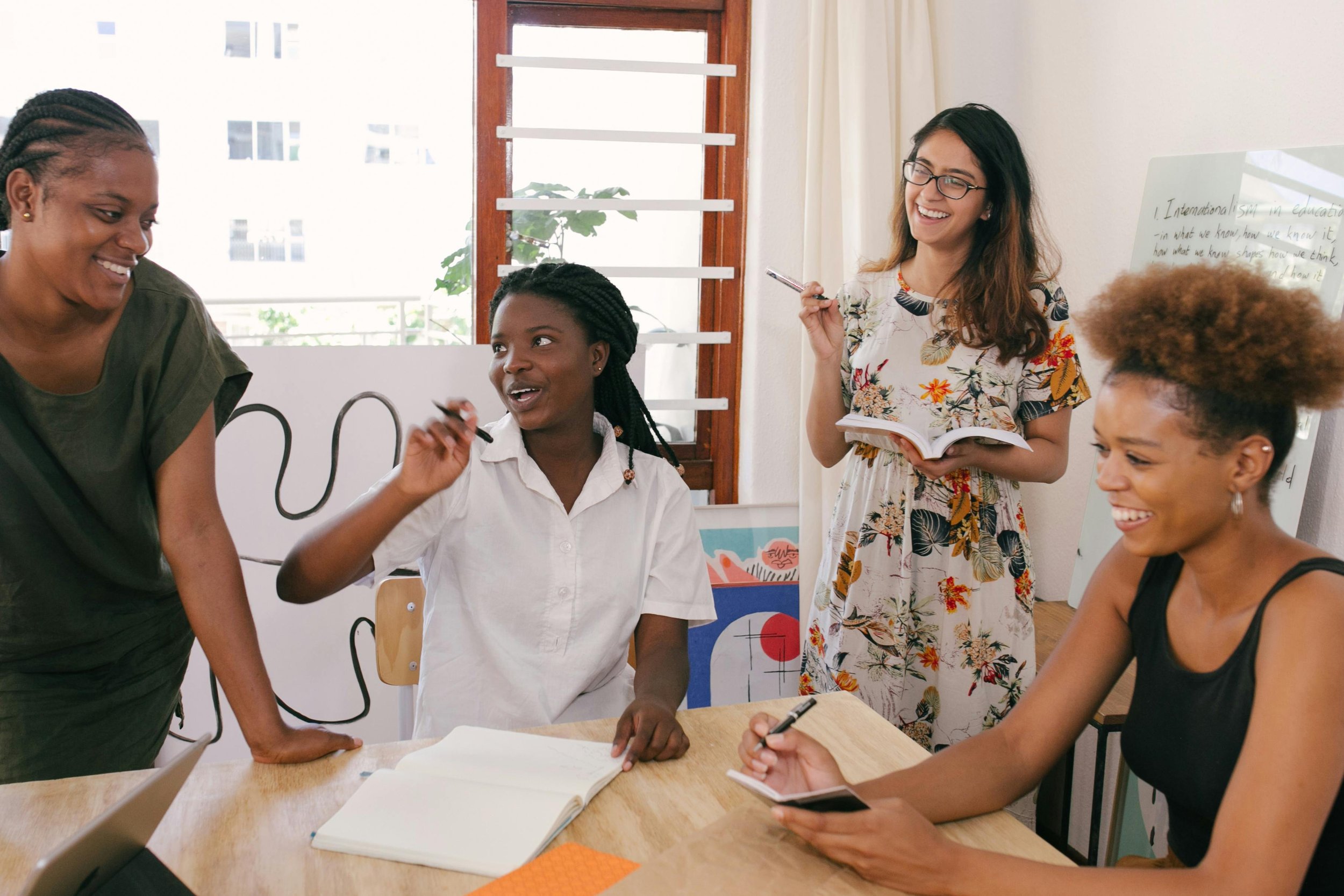 Image of a group of three women working together to solve an academic problem