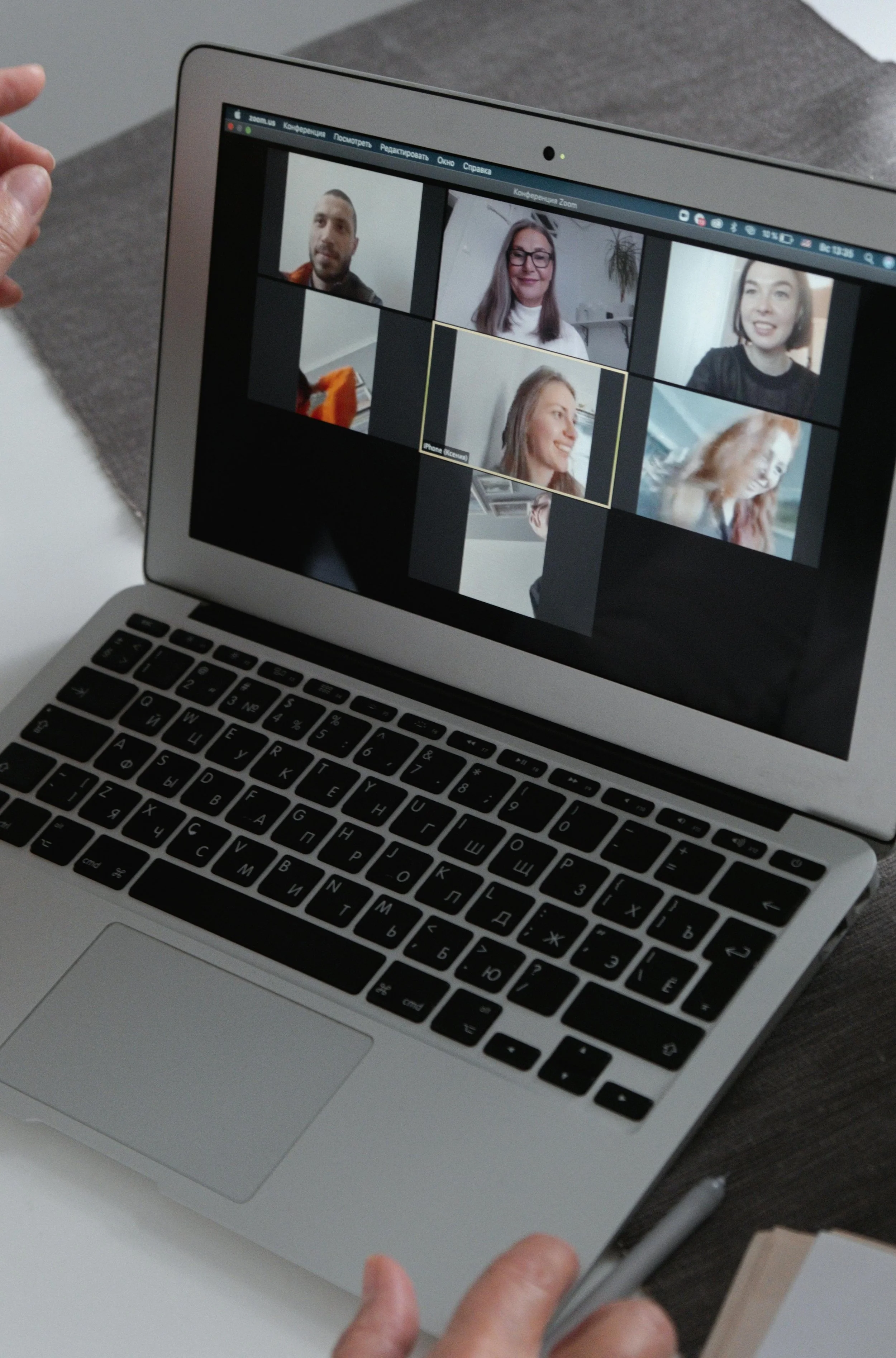 This is an image of a laptop with people virtually on the screen attending a webinar
