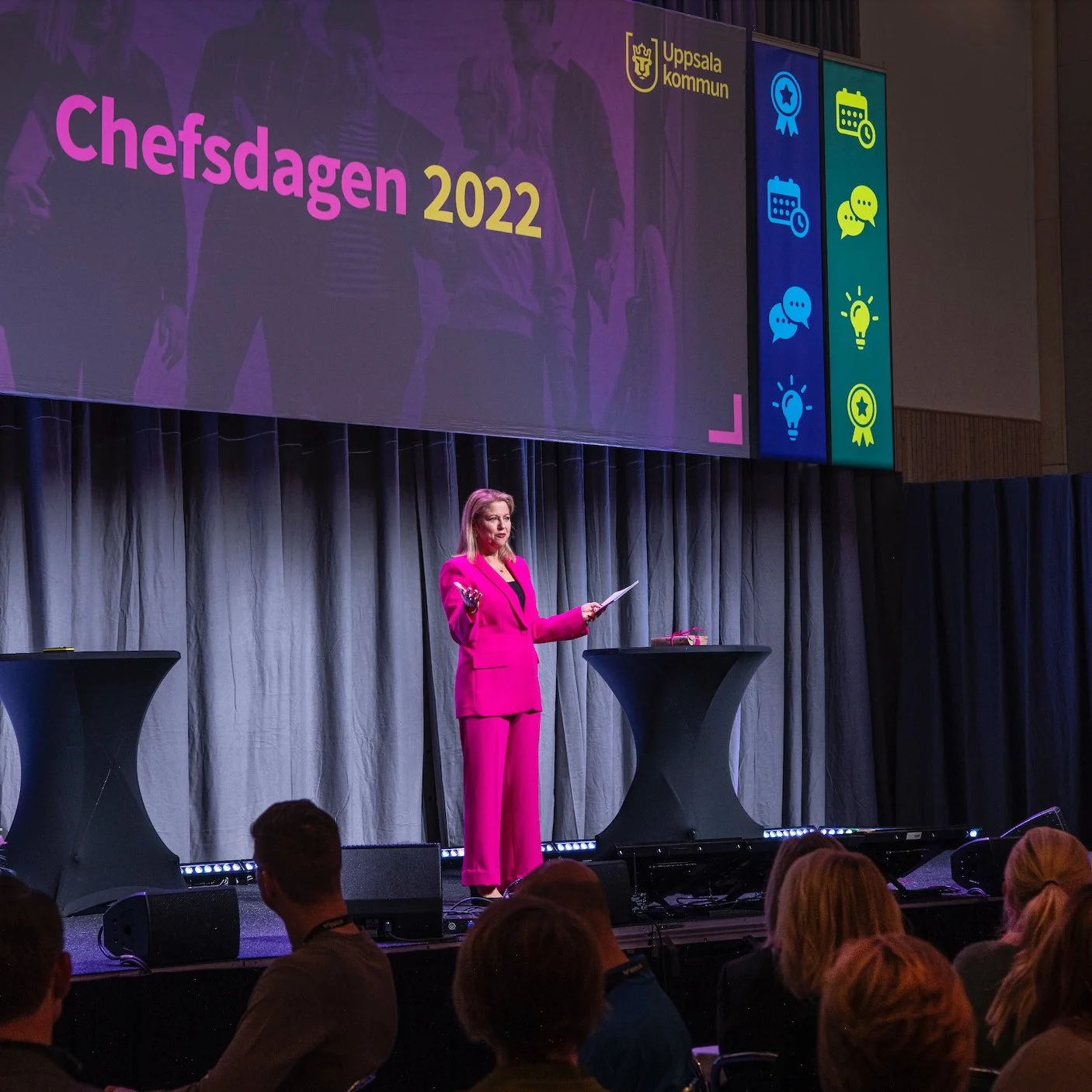 Sanna Balsvik moderator på chefsmöte i Uppsala, i rosa kostym