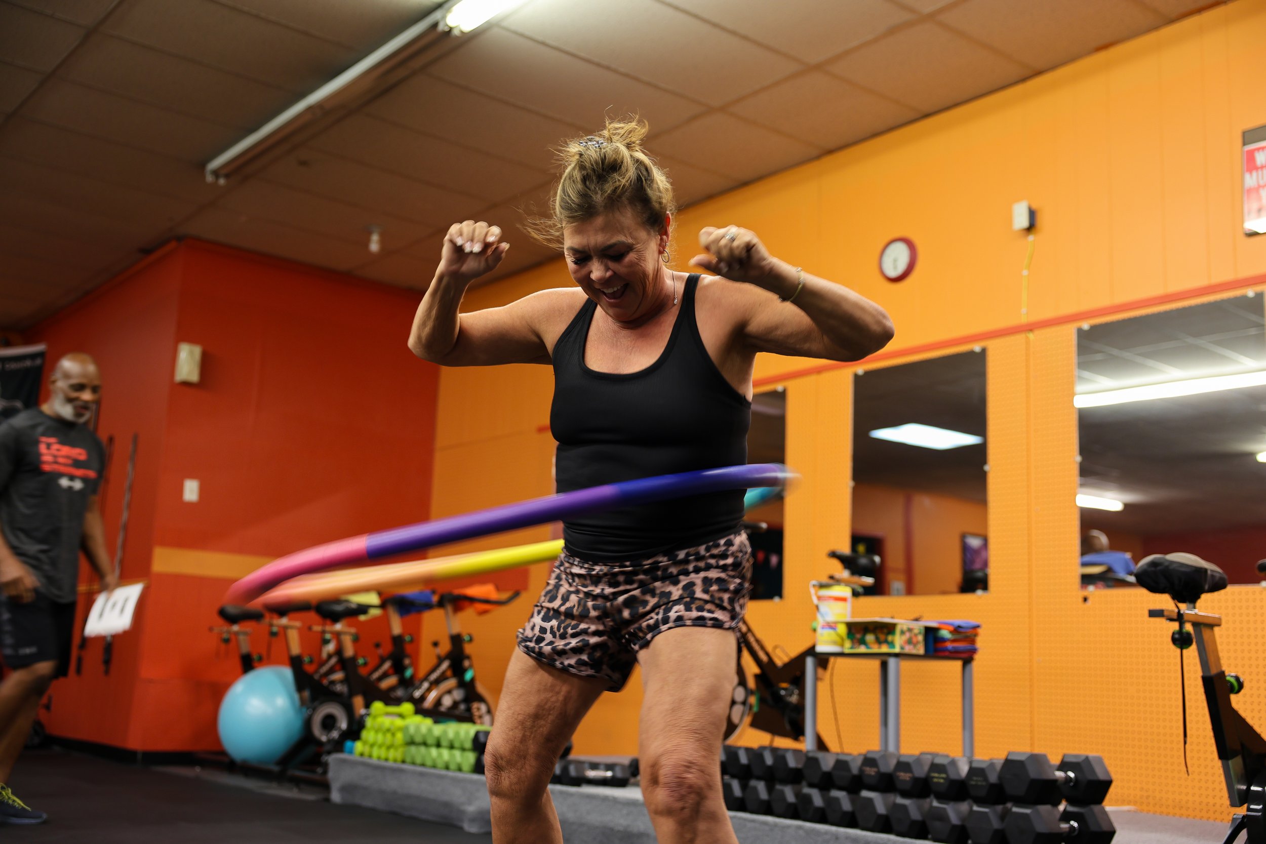 Tina showcases her hula-hooping skills during a workout class she co-leads at WillPower Studio. Committed to her health, she works out with a close group of friends every day at 5:45 a.m.
