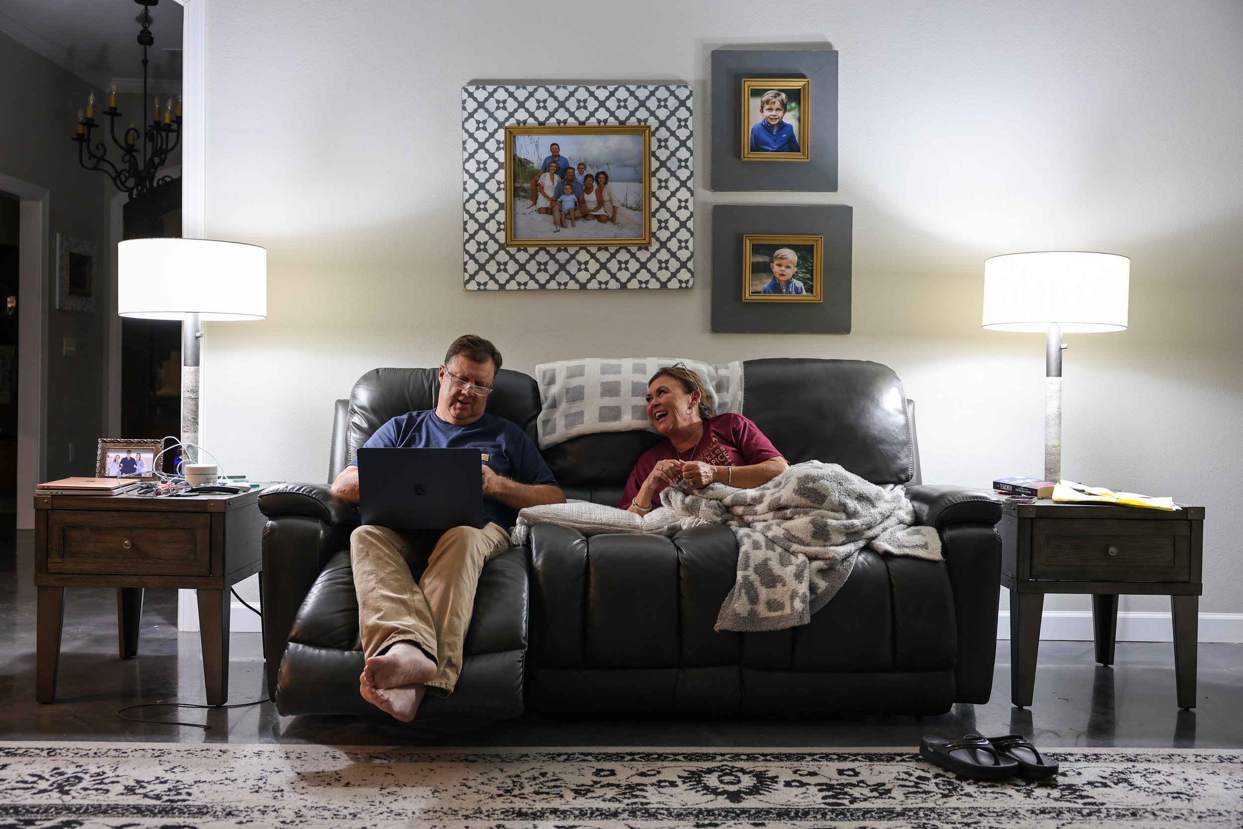 Tolliver Brown, 58, left, and Tina relax at home after a long day of harvesting. As part of their nightly routine, the Browns watch TV together before heading to bed, preparing for an early start the next day.
