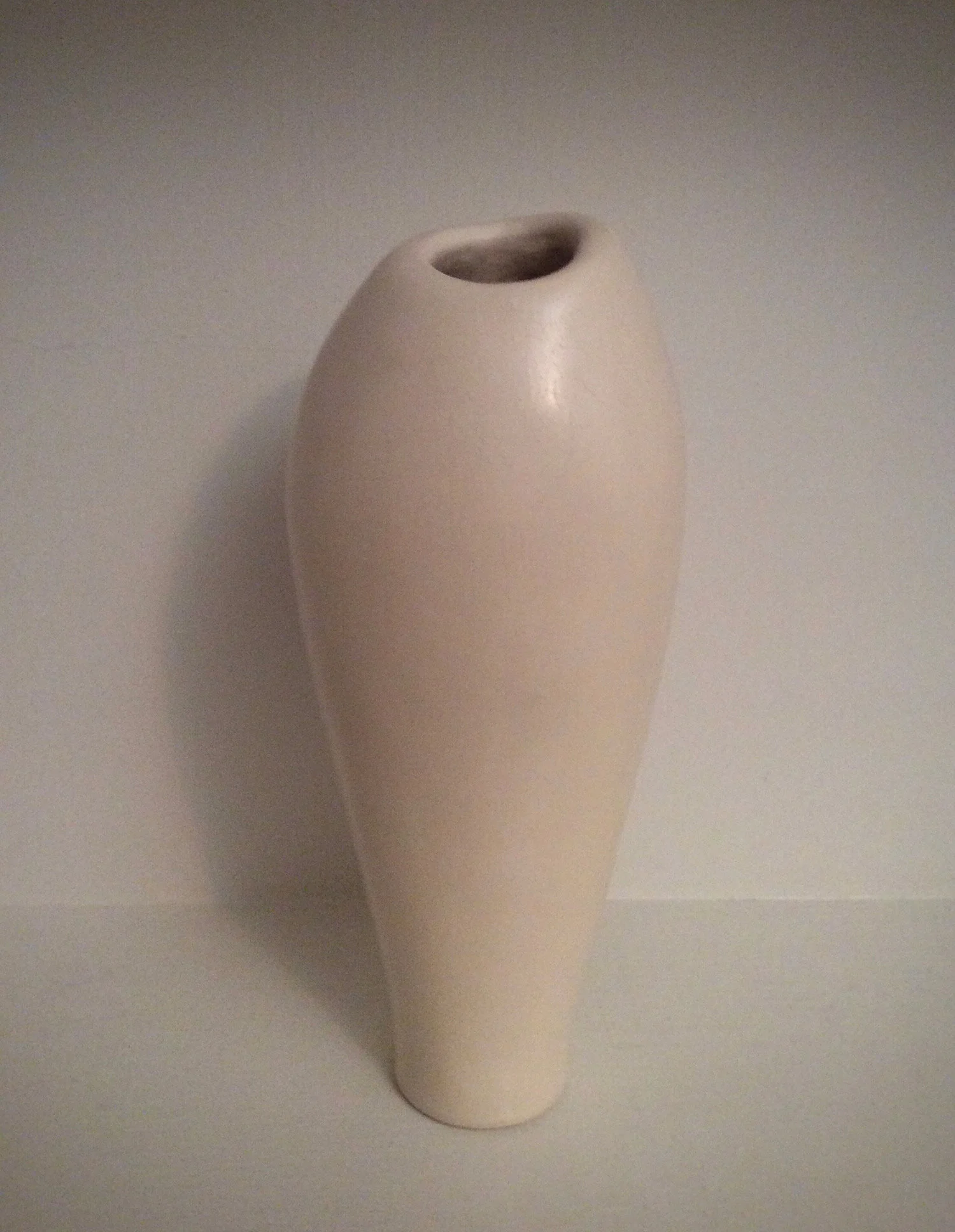 Asymmetrical white vessel. Terra sigillata surface.