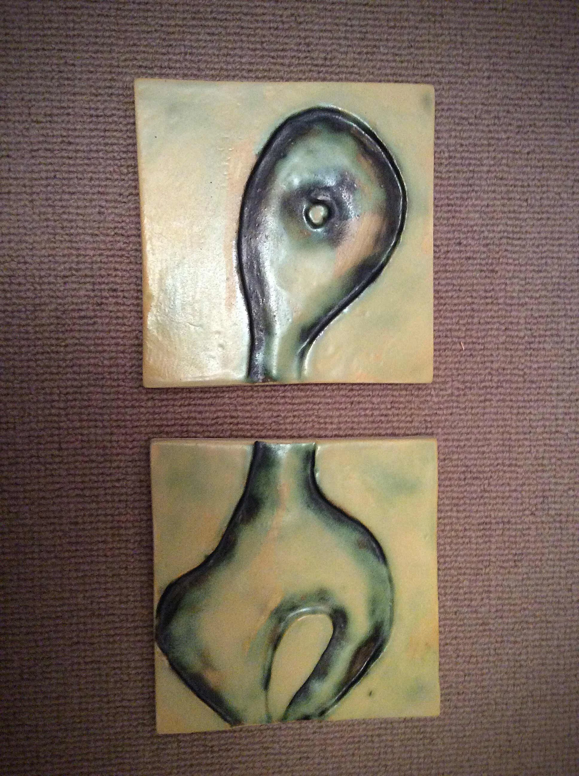 Two-piece wall hanging. Oxide under yellowish glaze.