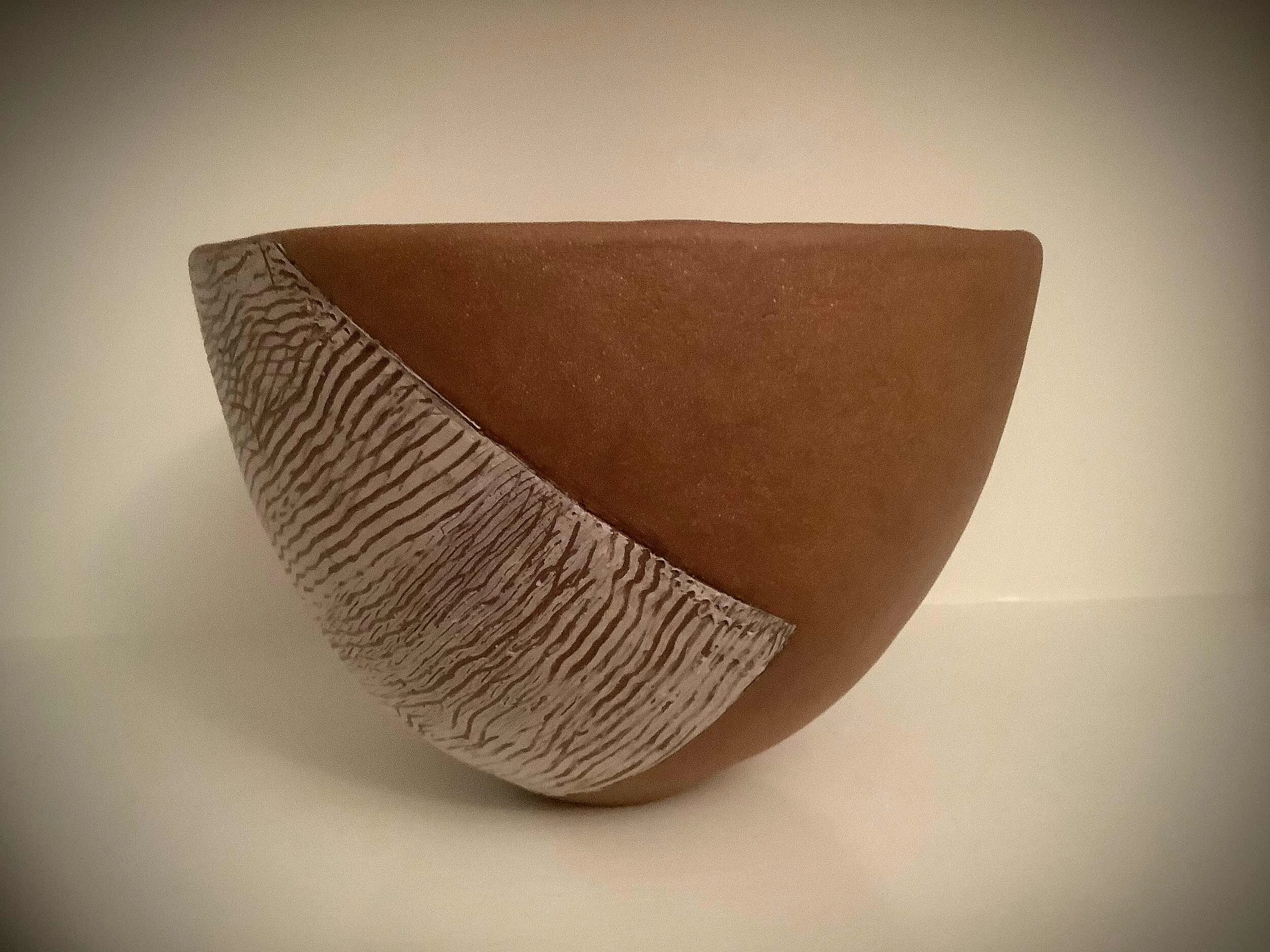 Red clay bowl. Red clay surface with porcelain design.