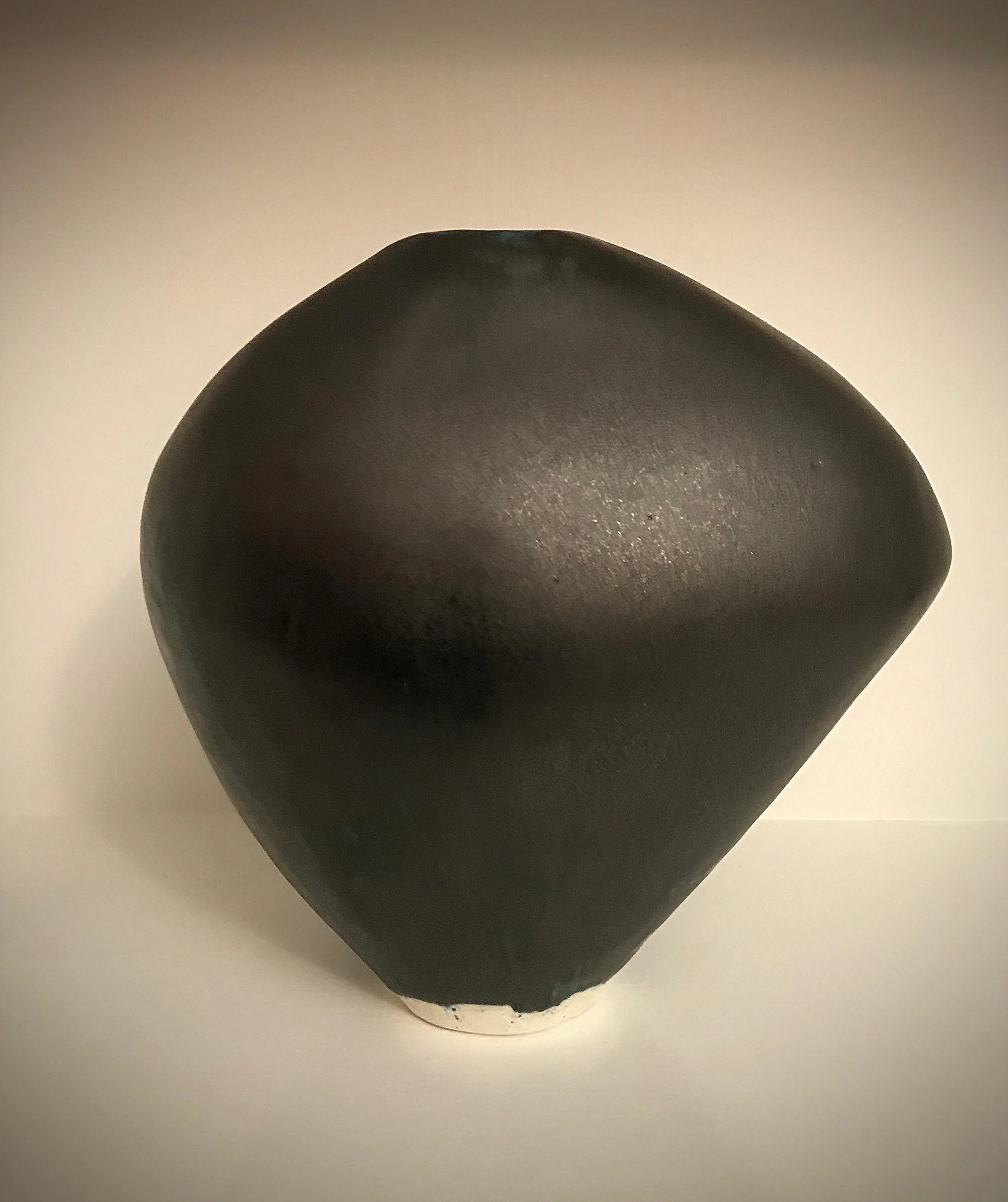 Black asymmetrical vessel. Glaze surface.