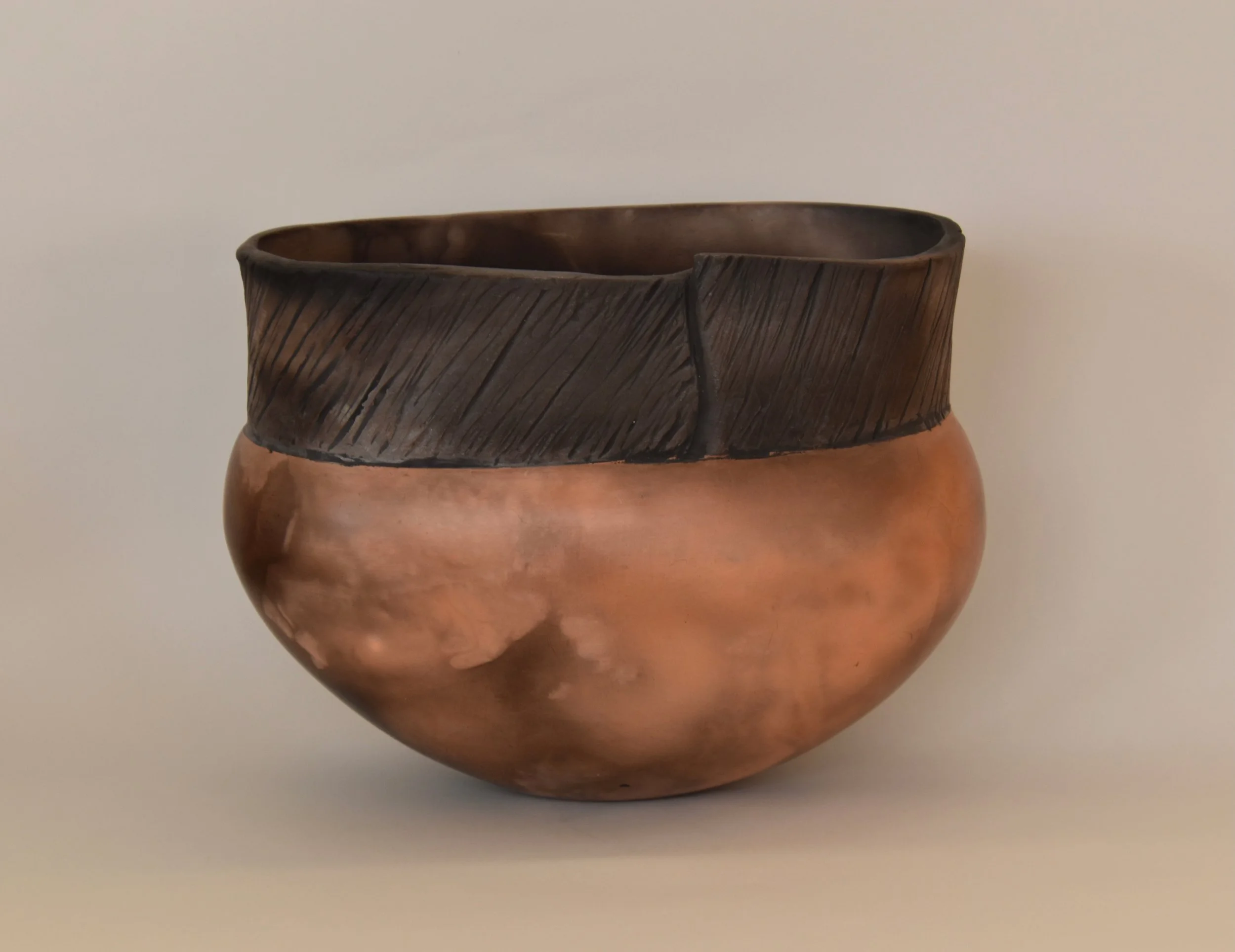 Smoke fired long oval vessel