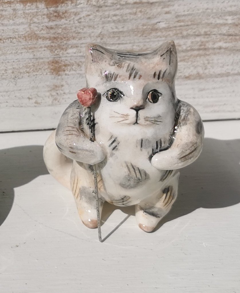 Grey cat with red flower