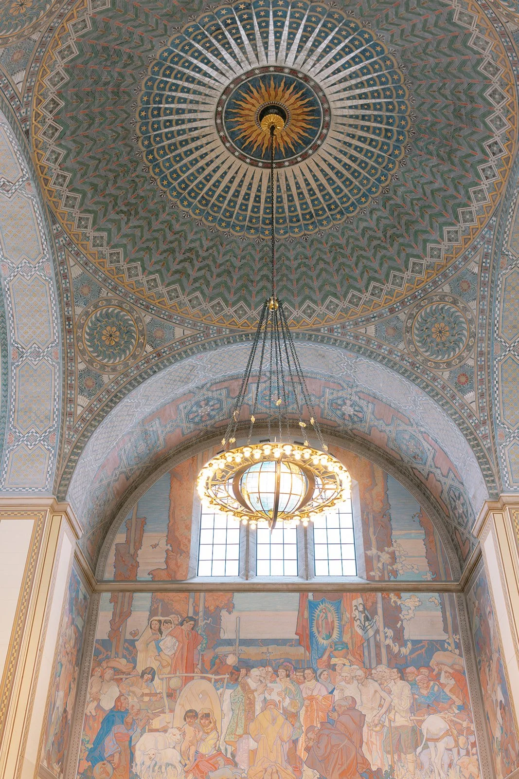 Painted ceiling and chandelier of the rotunda at the Los Angeles Central Library.