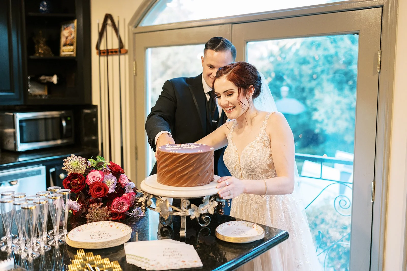 Bride and groom cutting wedding cake at the Houdini Estate, 