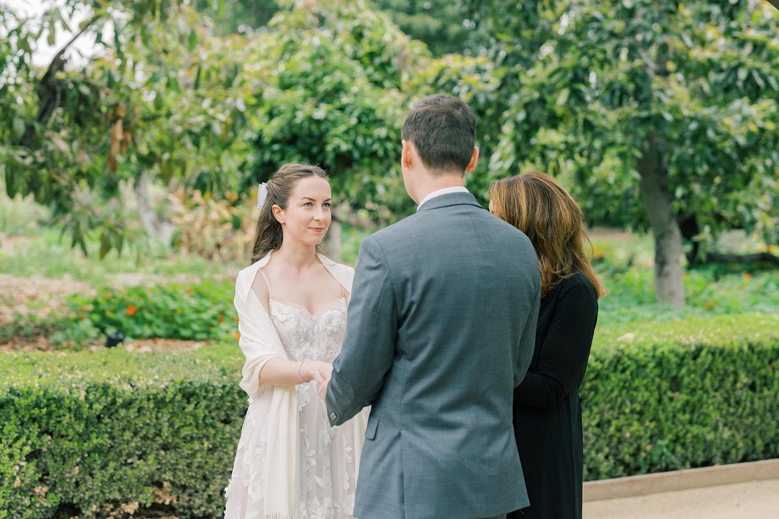 Smiling bride during her elopement ceremony at the Fullerton Arboretum