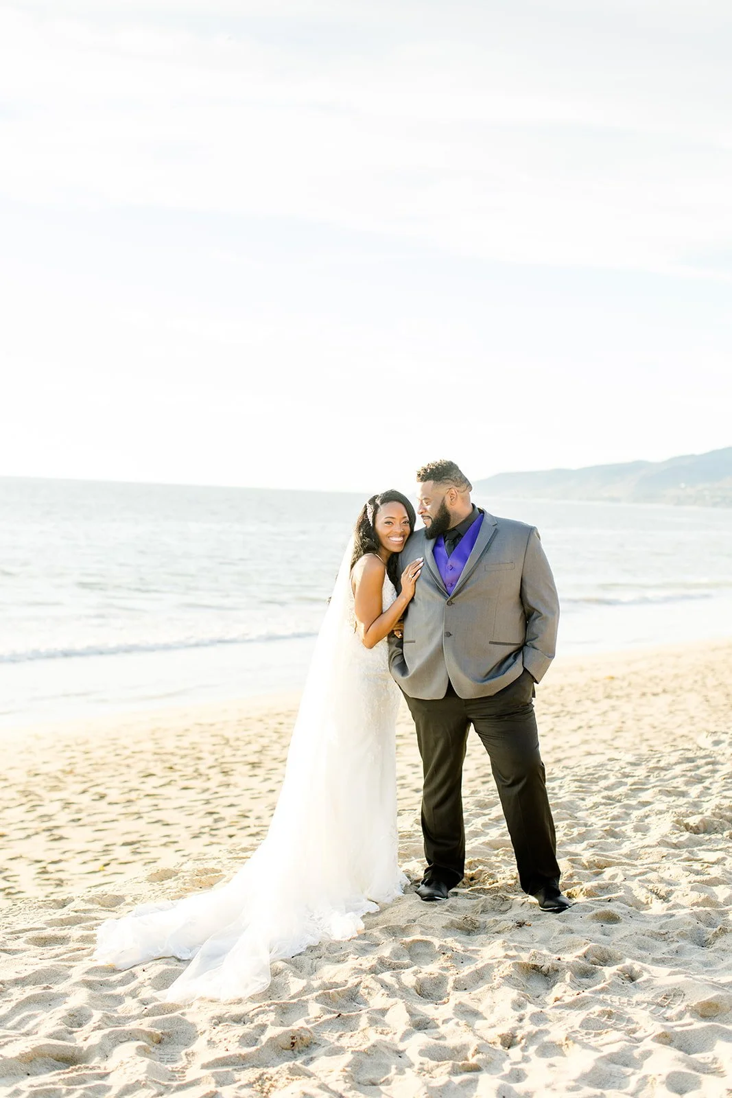 elopement couple posing on the shoreline at Point Dume, Malibu