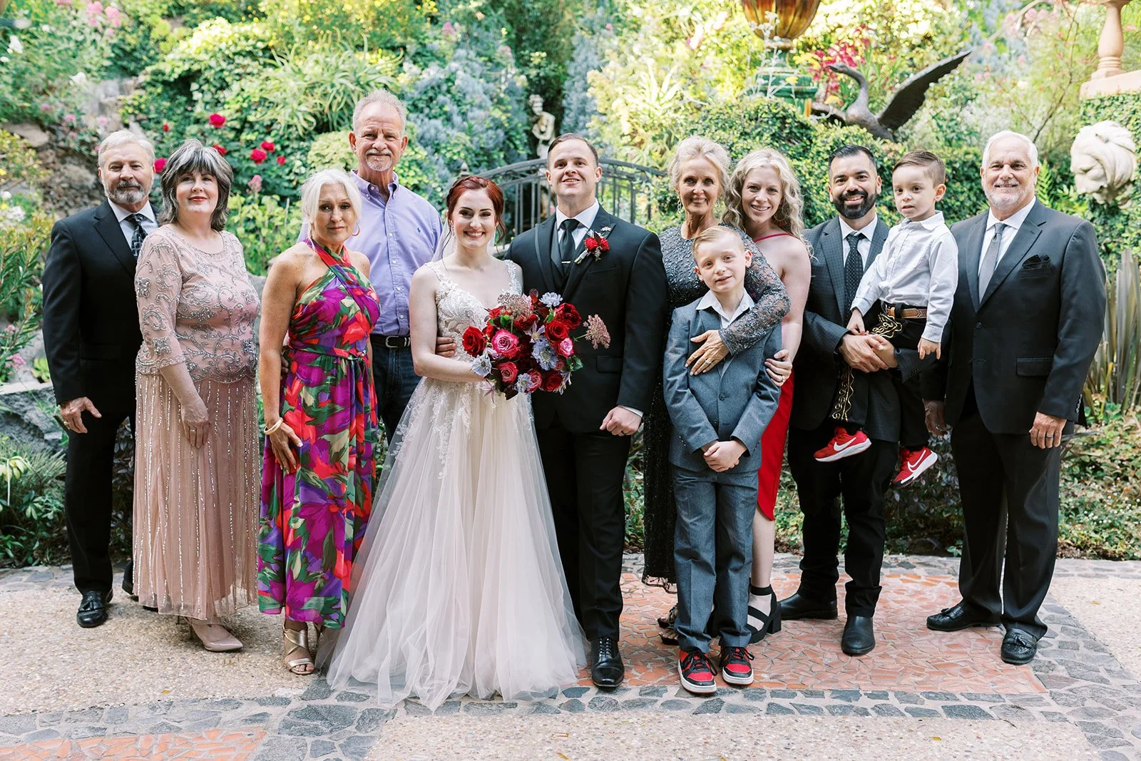 Portrait of the bride and groom with their families at their small wedding