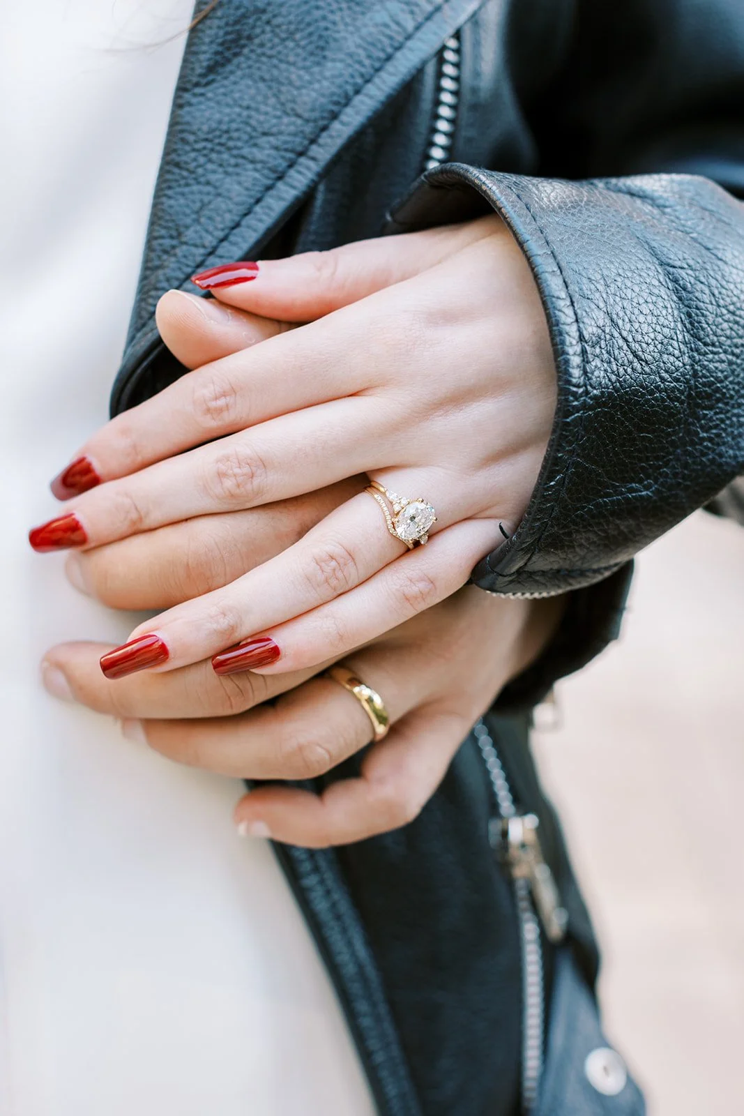Close-up of the bride and groom’s intertwined hands showing their wedding rings