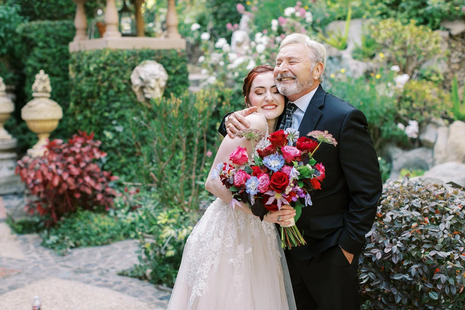 Bride and her father sharing an embrace on her wedding day in Los Angeles