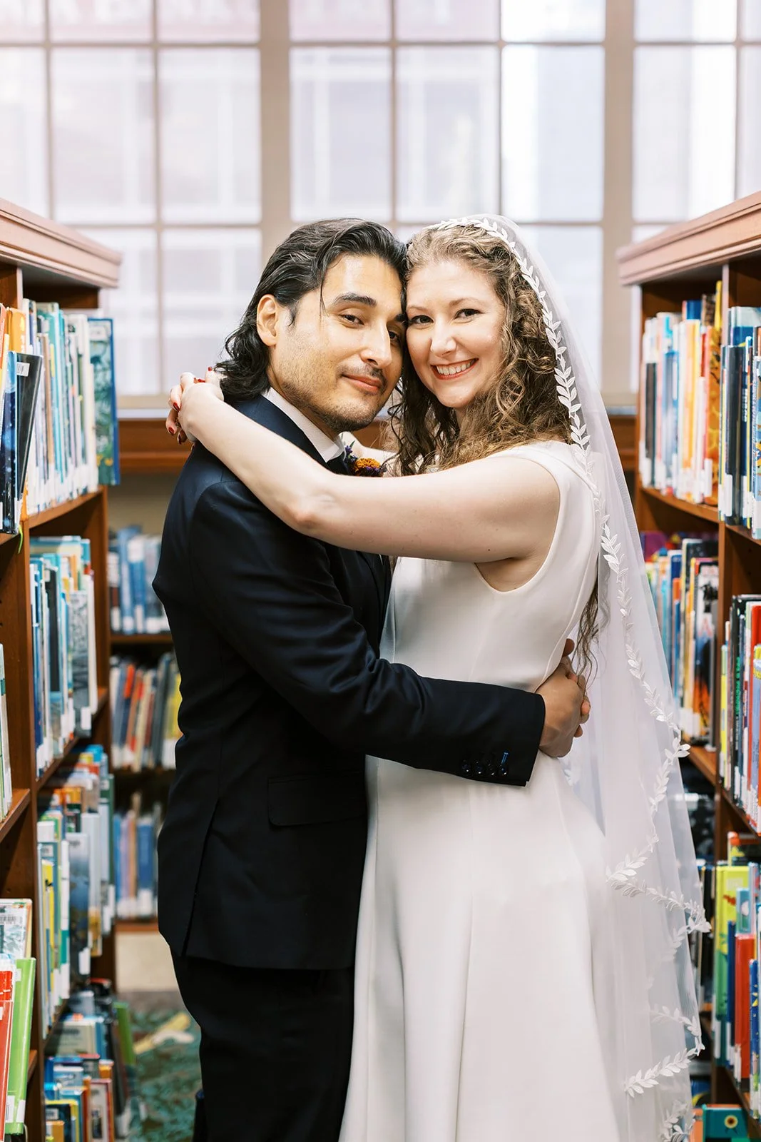 Bride and groom embracing in the stacks at the Los Angeles Central Library