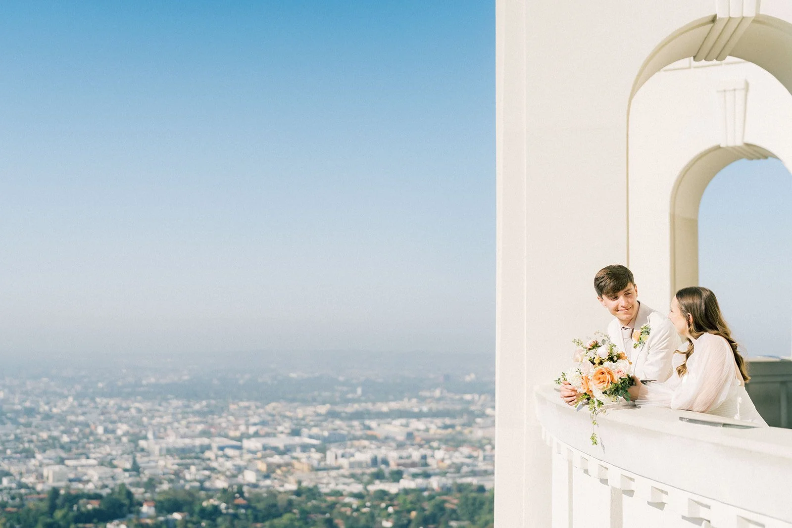 Elopement couple and view of Los Angeles from Griffith Observatory