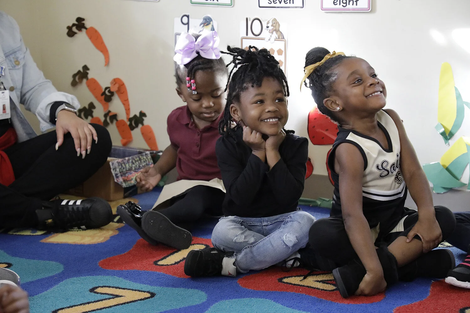  Louisiana Wolf Trap: three young girls are all smiles as they stare up at their teachers during an arts-integrated residency.  