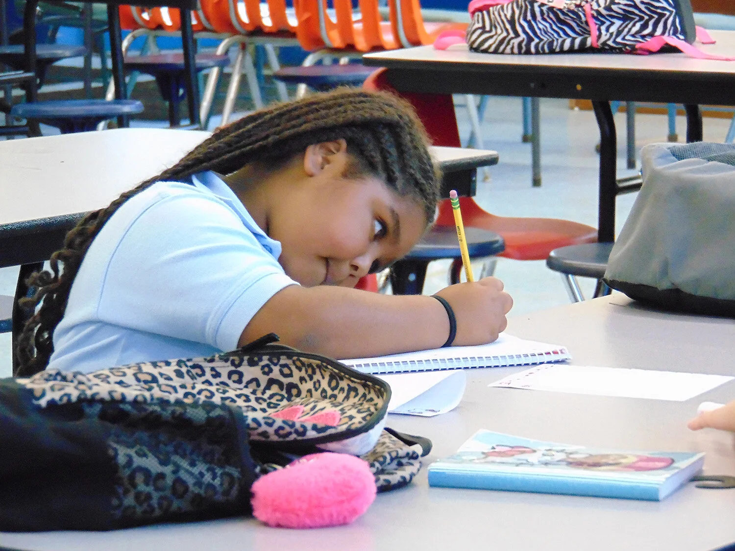  Afterschool and Summer Arts Enrichment Program: a young girl focuses on her work.  