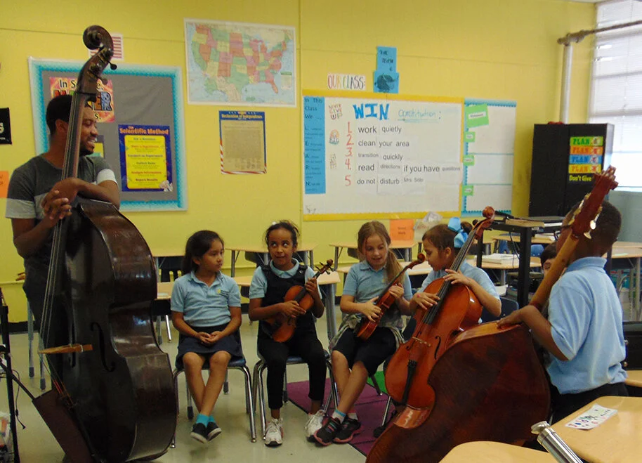  Afterschool and Summer Arts Enrichment Program: artist teaches strings.  