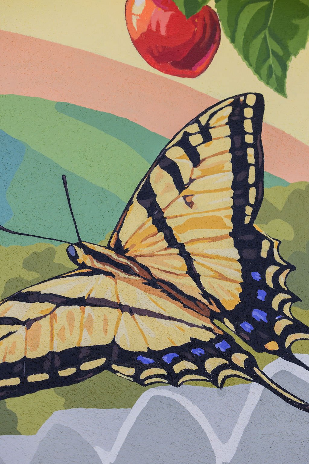 Bradley Elementary School Mural featuring grizzly bears, butterflies, honey bees, strawberries, green hills, red apples, blackberries, and other local flowers, creatures, and plants by Brittany Costanzo Creative 2026