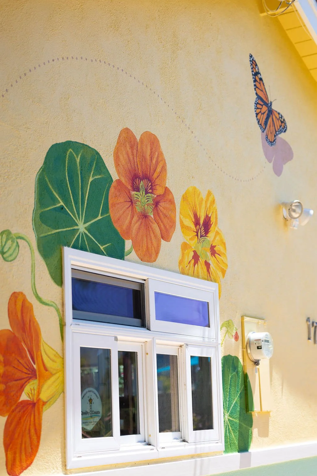 Santa Cruz Toddler Care Center Mural with nasturtium flowers, and a monarch butterfly by Brittany Costanzo Creative 2026