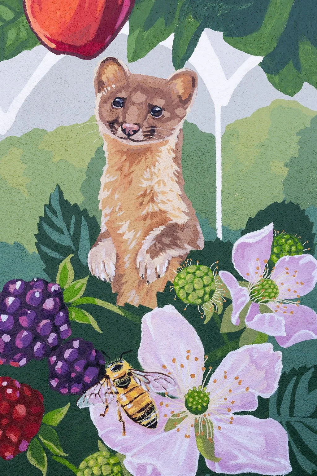 Bradley Elementary School Mural featuring grizzly bears, monarch butterflies, honey bees, strawberries, green hills, red apples, blackberries, and other local flowers, creatures, and plants by Brittany Costanzo Creative 2026
