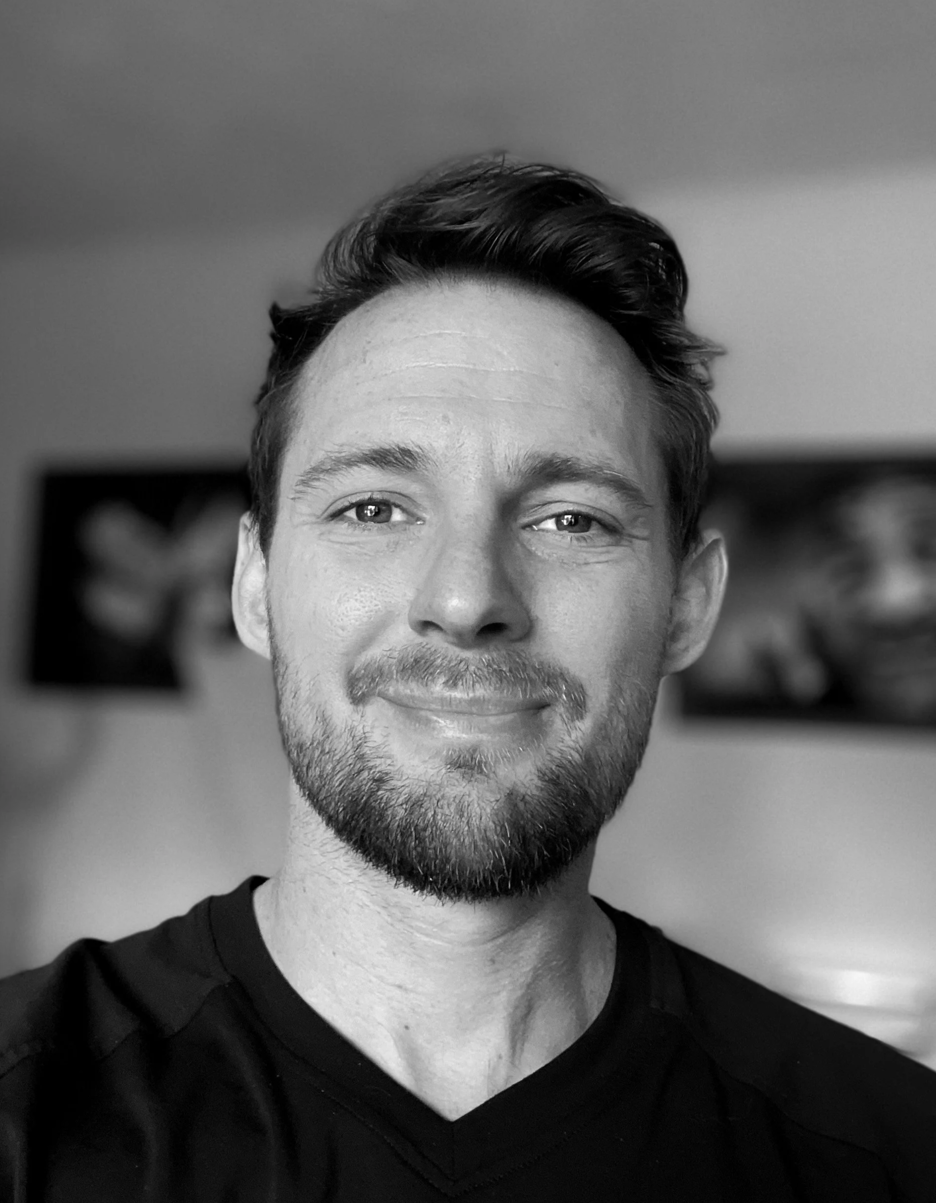 Black and white portrait of Zig, a pet portrait tattoo artist at Korl Tattoo in Denver.