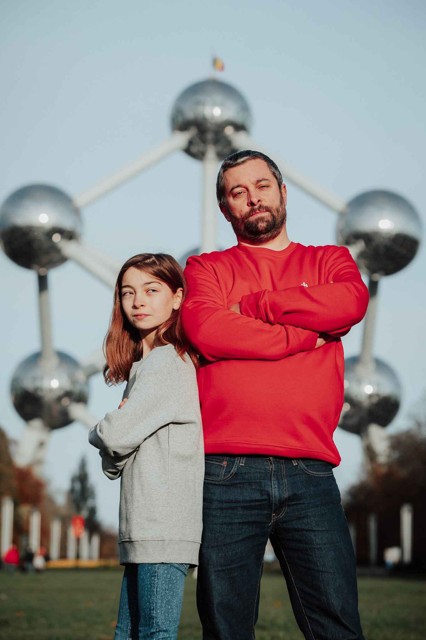 Nora is wearing a 9/11 grey sweatshirt & Nicolas is wearing a XL red sweatshirt.