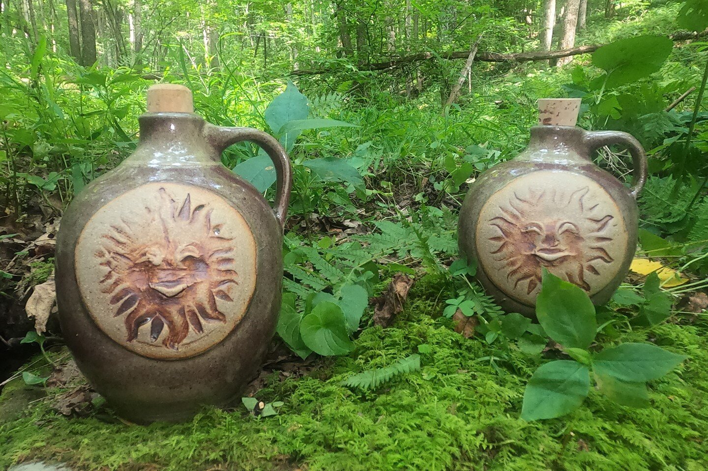 A pair of #sun #jugs resting in the forest. If you haven't heard, our website rifflepottery.com launched this week. Stop by and check out our #pots. Hope everyone has a happy #MugMonday.

#westvirginiamade #makingpottery #WVArtist #artisanmadepottery
