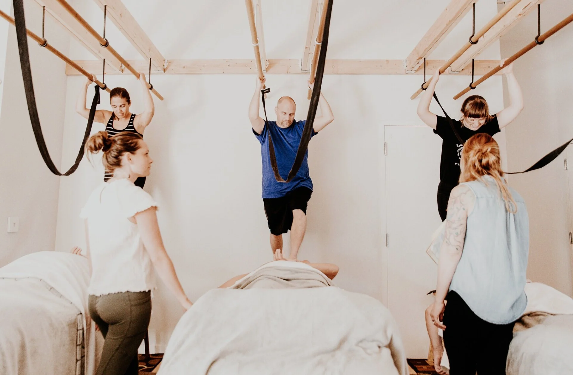 Instructor demonstrating Ashiatsu technique during a massage CE course