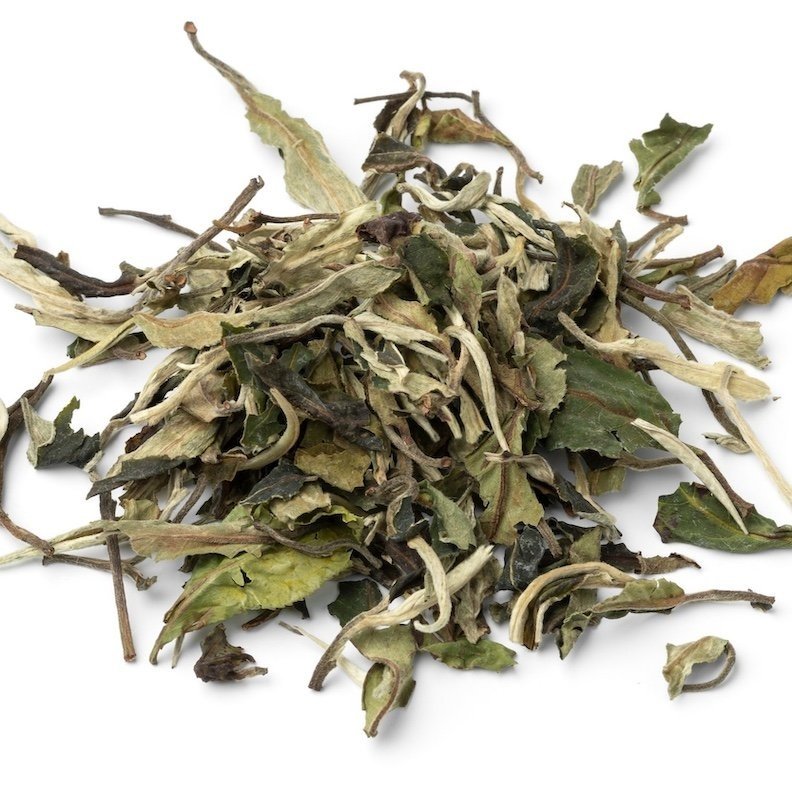 Strange Makes Silver Sip Bliss loose leaf tea on a white surface, a delicate herbal blend crafted for relaxation, clarity, and overall wellness.
