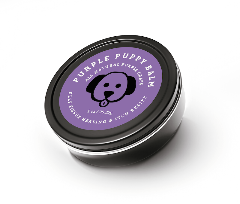 Strange Makes Purple Puppy Balm in a closed tin, an all-natural herbal salve for soothing dry paws, skin irritations, and minor cuts in dogs.