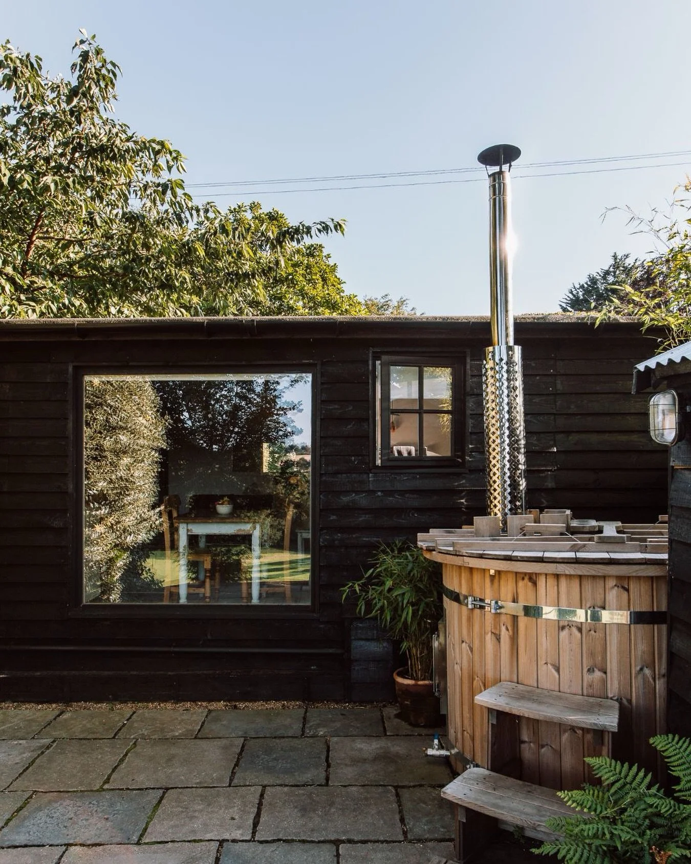 On the patio of Hill Cabin, you&rsquo;ll find a wood-fired hot tub, heated slowly and set against the open valley. For afternoons spent outside, and evenings when the only plan is to stay a little longer and watch the sky change.