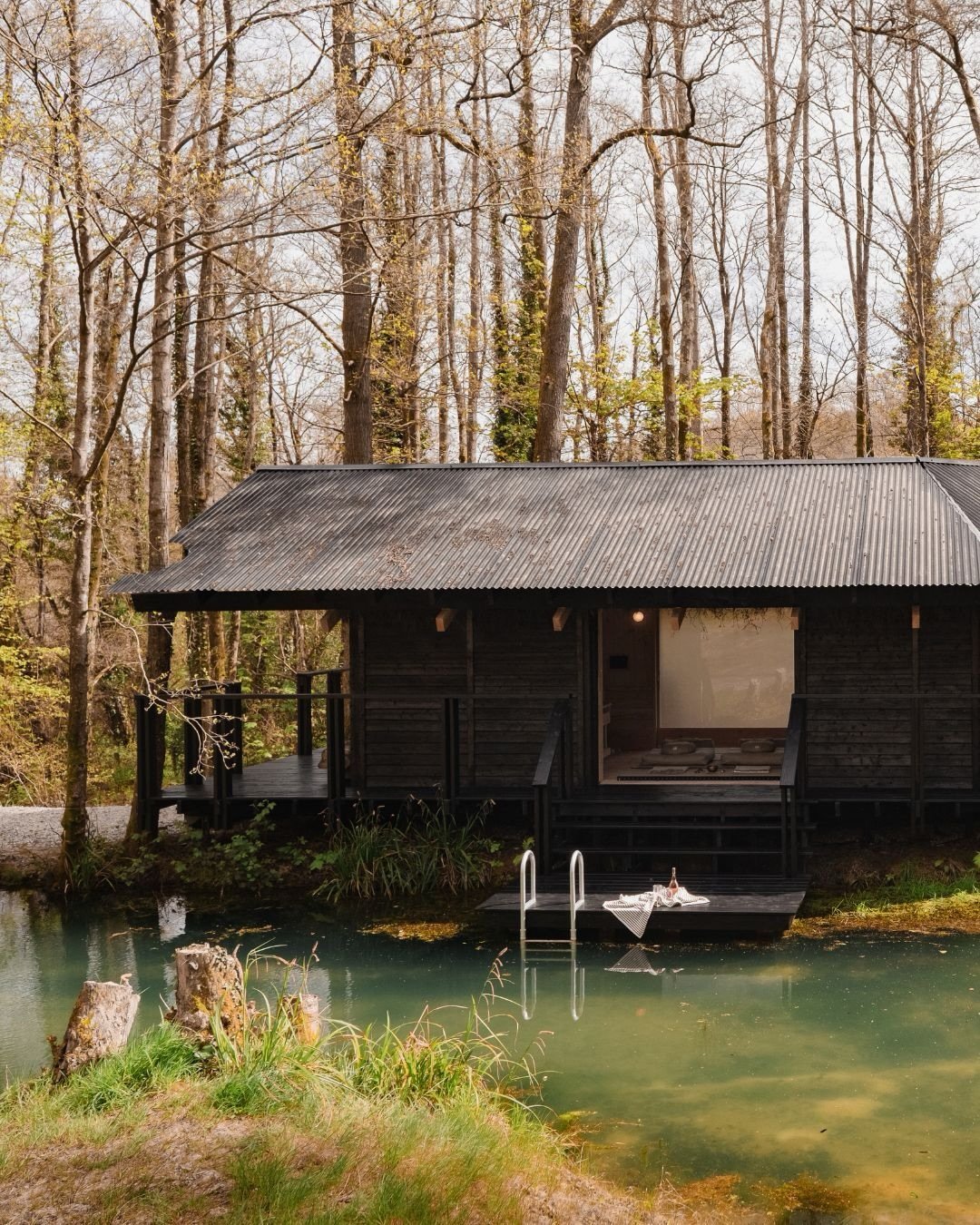 From outside to in at Yogi&rsquo;s Cabin.

The studio sits east to west, overlooking the private swimming lake. 

The same space shifts from lounge to studio &mdash; roll out the mat and the room changes with it. 

Fully kitted with Bare mats, blocks