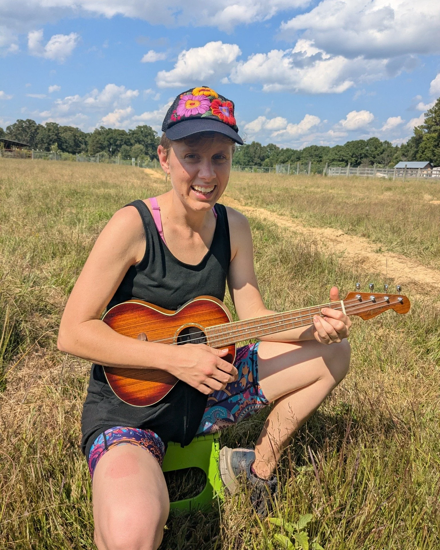 Sarah-Lyona with her ukulele in the sheep pasture