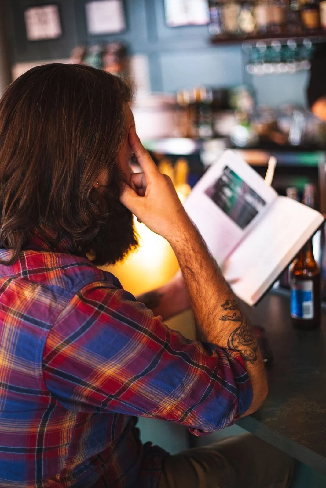 A guest looking over the menu at the bar at The Royal Room