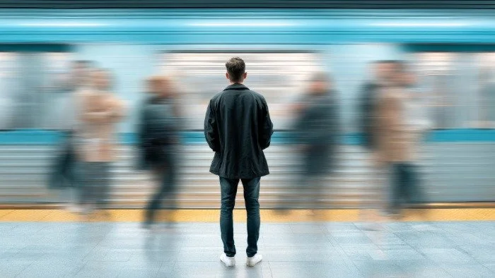 person standing in busy train station