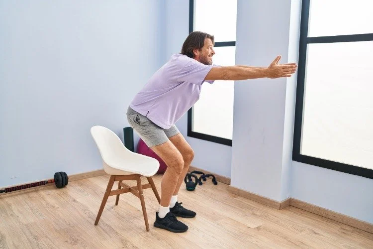 person doing sit to stands in chair