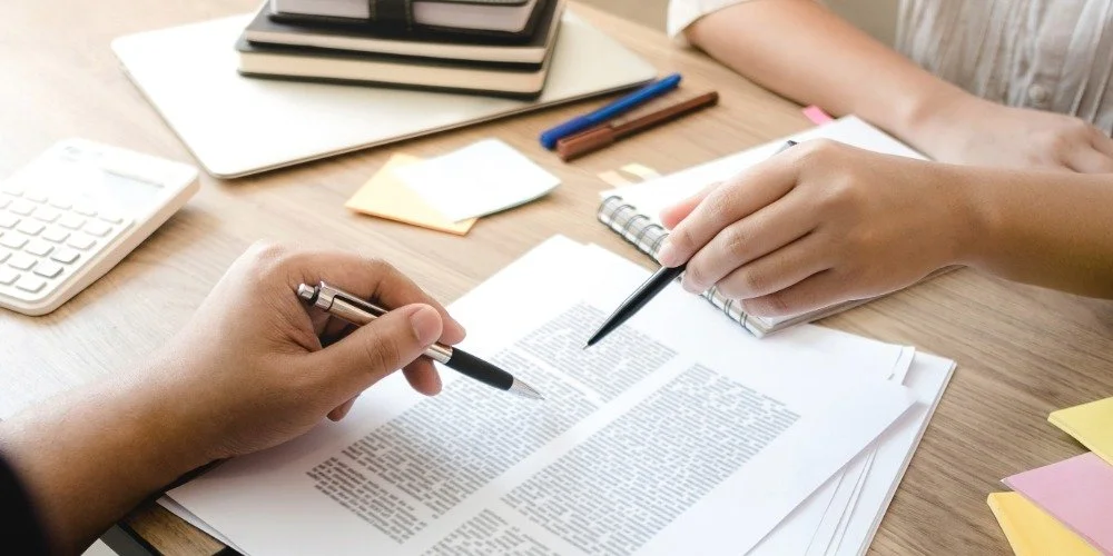 two people going over a research paper