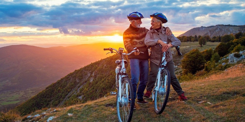 older couple at sunset on their bikes